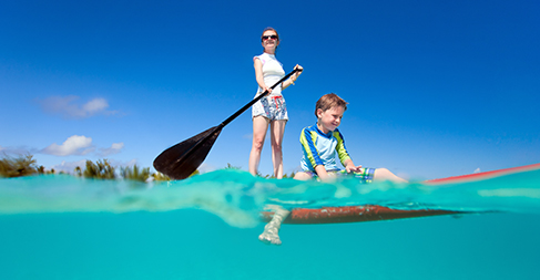 Mom and son paddleboarding 