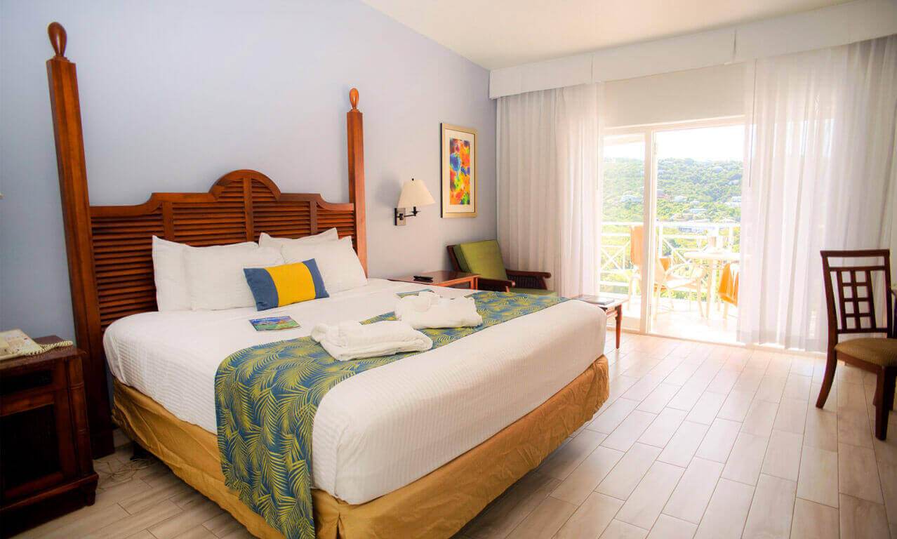 king size bed in room with a balcony