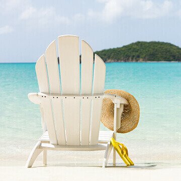 Chair on the beach with a hat