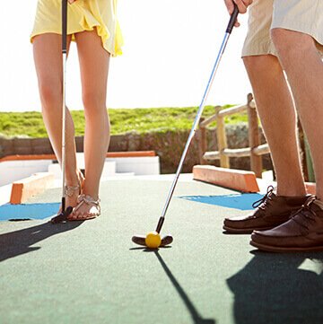 Couple Playing Mini Golf