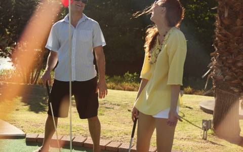 Couple Playing Mini Golf
